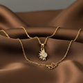 Sol y Luna gold sun and moon pendant necklace on brown silk
