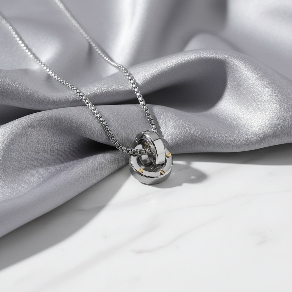 Eternal Bond Interlocking Ring Necklace on gray silk and white marble